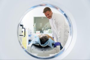 A Dr. doing a CT scan on a patient.