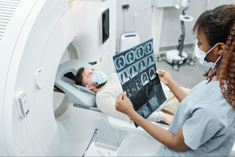 A Dr. looking at the results from a patient's CT scan.