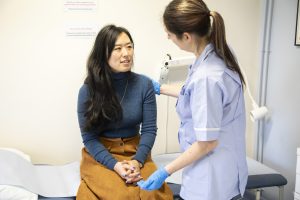 Nurse checking patient's vitals in clinic