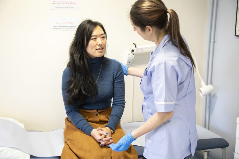 Nurse checking patient's vitals in clinic