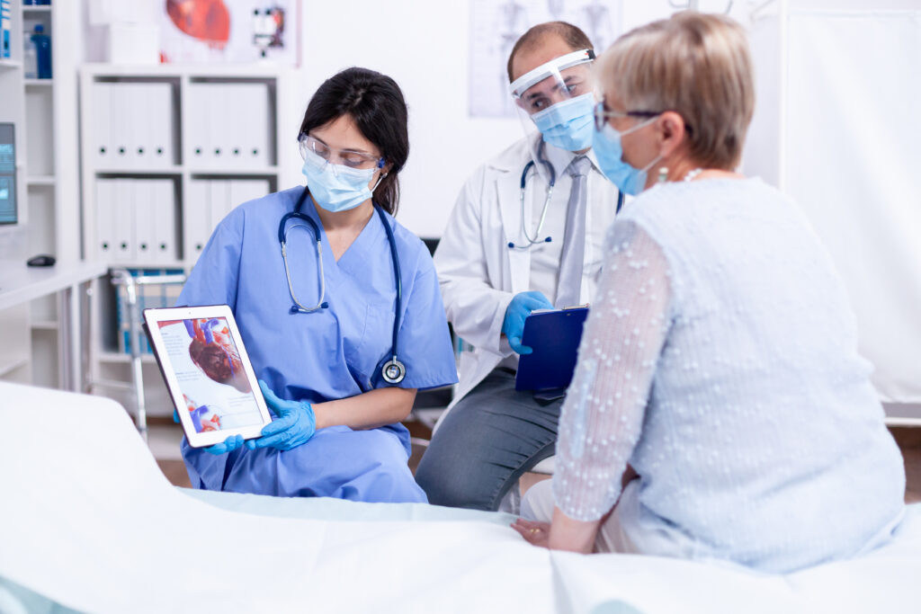 Doctor reviewing coronary CT angiogram results for preventive heart disease screening.
